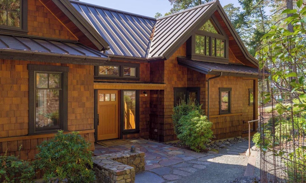 Orcas House | Magnificent waterfront home where sustainability meets luxury. Five private wooded acres, 400ft of rocky bluff shoreline, Chef's Kitchen, Stone Fireplaces, Heated Tile Floors & Unforgettable Sunsets over Wasp Passage. Your perfect PNW escape awaits.