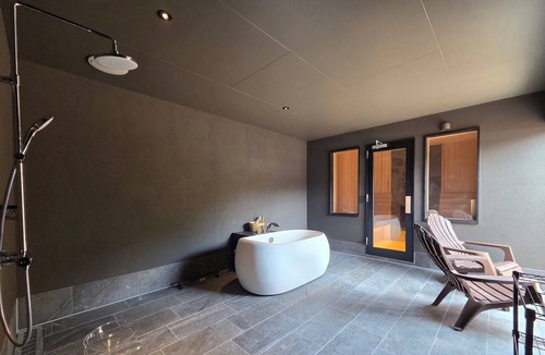 Hakone House | A vacation rental featuring a terrace, garden, and sauna—the entire house is yours! With Mt. Daimonji right before your eyes, take some time to relax in the spacious bus sauna.